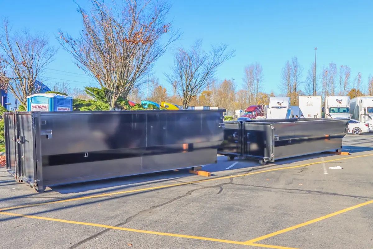 Professional dumpster rental service with roll-off container on residential driveway in New Canaan